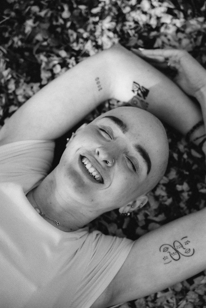 black and white-bald-woman-laying-in-nature