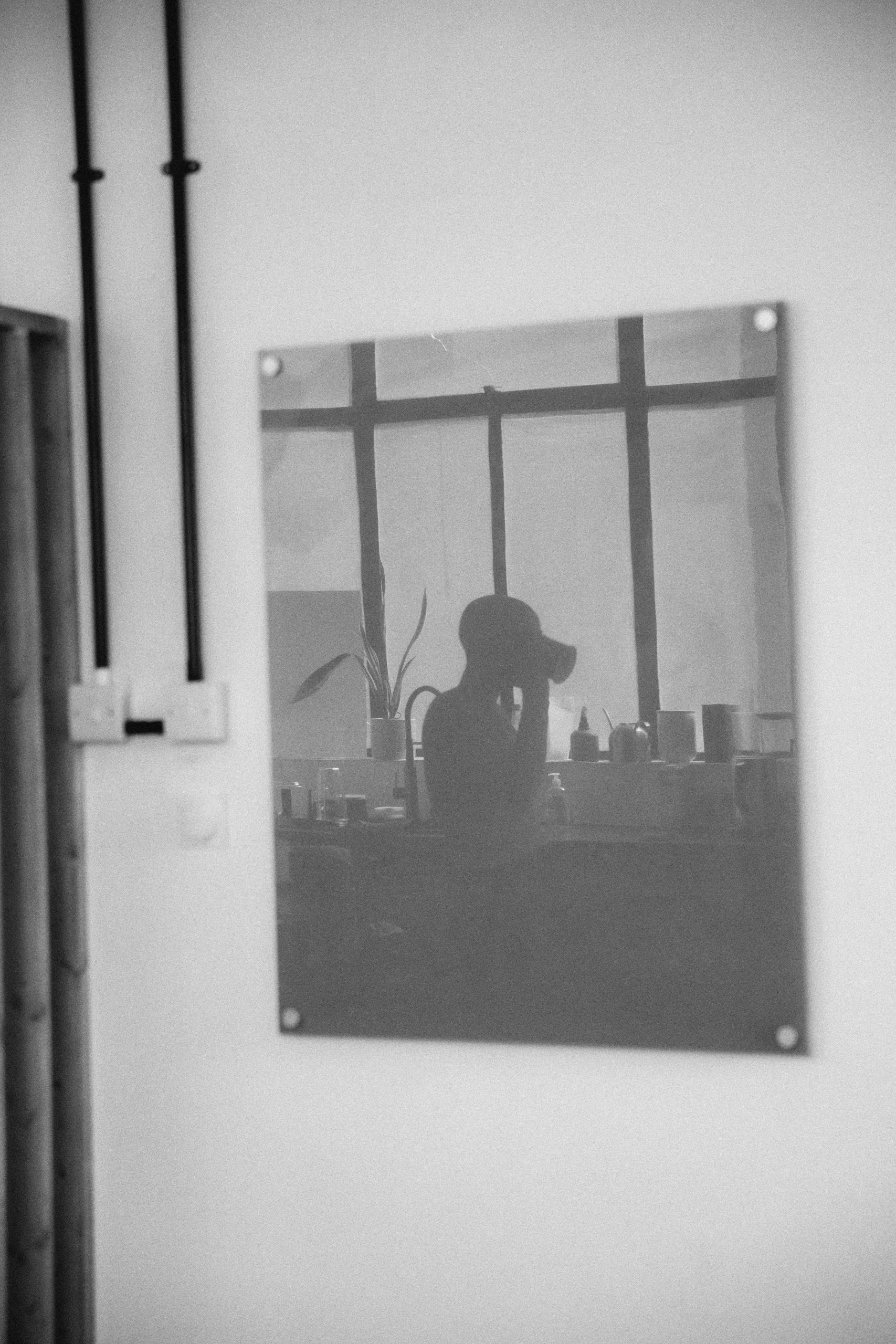 woman drinking coffee in black and white, yoga studio, bald