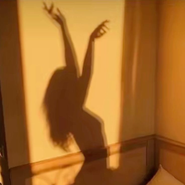 women-in-sun-shadow-dancing-hands-in-air